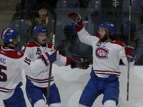 Kingston Voyageurs' Michael Schug, Kris Grant and Brett Dupy celebrate Dupy's goal against the Newmarket Hurricanes during Ontario Junior Hockey League playoff action at the Investa Centre on Sunday. (Ian MacAlpine The Whig-Standard)