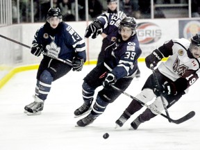 London Nationals' Blake Thomas, left, watches teammate Scott Lombardi and Chatham Maroons' Blayne Oliver chase the puck Sunday at Memorial Arena in Game 3 of the GOJHL Western Conference final. (DIANA MARTIN/The Daily News)