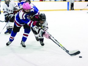 SEAN CHASE    The Franco-Ontarian Girls Hockey Tournament ended Wednesday with Les Dragons de Le Caron beating Georges-Vanier in the small school championship. Here Georges-Vanier's Joelle Lavoie (right) snatches the puck from Dragon Mikaela Poole.