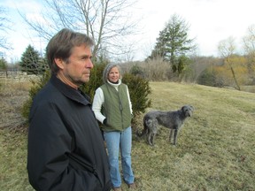 Keith Douglas, Elizabeth Bellavance, and their dog Victoria, enjoy the view from their farm on Aberarder Line in Plympton-Wyoming. The couple is opposed to Suncor Energy's plan to build a wind farm nearby. Open houses for the Cedar Point Wind Power project are being held this week. (PAUL MORDEN, The Observer)