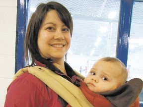 Alisa Murray and her one-year-old son, Deegan Murray, watch Sangudo Community School teachers/staff compete with the Grade 6 students in a game of hockey held at Sangudo Arena on the evening of Tuesday, March 26.