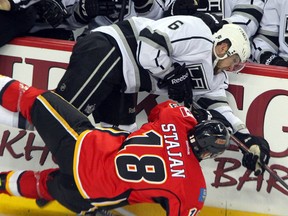 Los Angeles Kings Jake Muzzin (top), seen here hitting Calgary Flames Matt Stajan during their Feb. 20, 2013 game, was named the NHL rookie of the month for March. In 17 games Muzzin had four goals and seven assists with a +10 rating. (Jim Wells, QMI Agency)