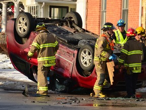 Owen Sound firefighters prepare to extricate occupants of a van that was flipped onto its roof at the corner of 9th St. and 2nd Ave. W. in this photograph taken in January 2011.