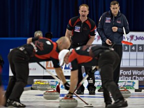 Team Canada skip Brad Jacobs shouts to Ryan Fry (left) and Ryan Harnden during their win over the U.S. late Monday night.