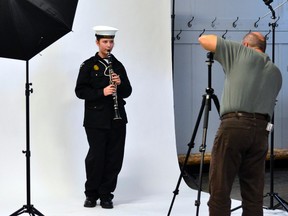 Ordinary Seaman Sarah Currington poses with her clarinet as Sea Cadet alumnus Gilles Portelance takes her picture. Portelance and fellow members of the Porcupine Photo Club visited Royal Canadian Sea Cadet Corps Tiger for a special photo session, held at no cost to the unit.