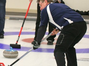 Wayne Wald, skip of the Nortech team watches as Mike Debianko, John Kuran sweep in a stone thrown by Ed Luck in the Third Event final of the Oilmens Bonspiel held this past weekend at the Fairview Curling Club. Nortech was playing against the Spice rink. A total 24 teams competed. See more details on page 8