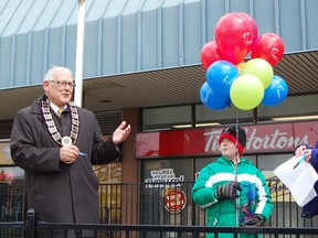 Mayor John Lessif; left, was joined by Matthew Crotty; centre and Dr. Lisa Dalby; right, Tuesday afternoon as Tillsonburg residents gathered to celebrate the first World Autism Awareness Day in Canada. The United Nations General Assembly declared April 2 as World Autism Awareness Dayin 2007. The disorder is now believed to affect tens of millions globally, including over 100,000 people in Ontario.   
KRISTINE JEAN/TILLSONBURG NEWS/QMI AGENCY
