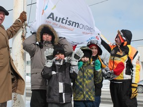 Students and staff at Golden Avenue Public School marked World Autism Day with a little help from Timmins Mayor Tom Laughren as they raised an autism awareness flag in front of the school. Back row, from left, are Laughren, Jack Szostak, Braxton Arcieri and Evander McGrath. In the front row are Joshua Cogar and Evan Gooderham.