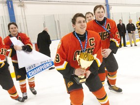 Elgin-Middlesex Chiefs captain Travis Konecny, left, flanked by Lawson Crouse, right, skates with the championship trophy after beating the Waterloo Wolves in Game 4 of the Alliance Hockey final in Waterloo on March 2. Konecny could go first overall to the Ottawa 67’s in the Ontario Hockey League Priority Selection on Saturday and Crouse could go fifth overall to the Kingston Frontenacs. (Craig Glover/QMI Agency)