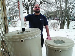 Stephen Sottile, conservation officer with Utilities Kingston, displays the rain barrels that are available for Utilities Kingston customers. The rain barrel program is designed to help Utilities Kingston address system constraints during the warm summer months.       Katrina Geenevasen - Kingston This Week