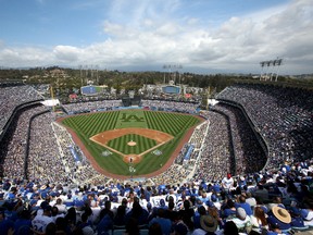 Fans packed Dodger Stadium for the Los Angeles Dodgers first home game of the 2013 Major League Baseball Season on Monday against the San Francisco Giants. Two of the items available through the St. FX Baseball Academy’s auction are trips to Los Angeles and San Francisco to see a game. Getty Images/AFP