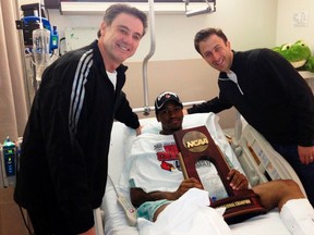 Louisville coach Rick Pitino (L) and Florida International University head coach Richard Pitino visit Kevin Ware in his hospital room at the Methodist Hospital of Indianapolis in Indiana, in this image tweeted by the University of Louisville on April 1, 2013. (REUTERS/The University of Louisville/Handout)