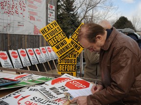 Plympton-Wyoming resident Jim Gryner fills out an objection letter outside the Suncor public open house in Camlachie Tuesday. Dozens of Plympton-Wyoming residents showed up to voice their opposition against the company's Cedar Point wind turbine project. (BARBARA SIMPSON / THE OBSERVER / QMI AGENCY)