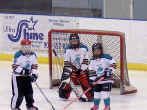 Paris U10 ringette players Zoe Falkiner (9), left, goalie Jordan Wood (10) and Olivia Wight (4) defend the net on Friday, March 29 in Niagara Falls against the Burlington Blast during the team's last game of the 2013 season. SUBMITTED PHOTO