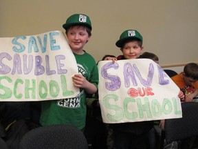 Zack and Devin Deakins used handmade signs to plead with Bluewater District School Board trustees at a meeting in Chesley Tuesday night to keep their school open. A final decision on the school’s fate will be made June 18.