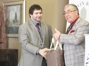 Mayor Bill Elliot, right, presents outgoing Chamber of Commerce executive director Alan Greene with a token of appreciation on behalf of the city during the chamber’s monthly luncheon March 25.