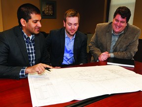 Diagrams for an anticipated Speedy Transport terminal in Prescott are viewed by architect Omar Gandhi, Speedy CEO Jared Martin and Mayor Brett Todd at town hall Wednesday. (NICK GARDINER/The Recorder and Times)