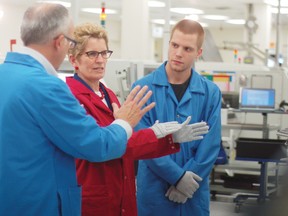 Premier Kathleen Wynne speaks with Dan Bergeron and Randy Swoffer of SigmaPoint Technologies in Cornwall in this file photo. The company announced Friday, Oct. 31, it has received a major new contract.
File photo/CHERYL BRINK