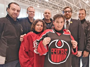 Gabe Costantini (front left) and Marcos Neziol of the Brantford 99ers minor peewee AA team check out the new jersey of the Brantford 99ers Junior B hockey team on Wednesday at the Wayne Gretzky Sports Centre in Brantford.  Joining them are Mayor Chris Friel and team owners (from left) Mike Spadafora, Ken Lindsay, Scott Rex, Paul Polillo and Darren Dedobbelaer.  (BRIAN THOMPSON The Expositor)