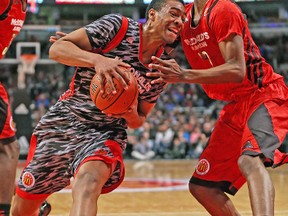 Jabari Parker drives against Andrew Wiggins during last night’s McDonald’s All American game in Chicago. (GETTY IMAGES)
