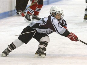 Tillsonburg AE atom Steve Lee stretches for the puck during a Southern Counties B semifinal against Six Nations Saturday in Tillsonburg. The Tornadoes won 9-0. Six TMHI teams will be playing in A or B finals this weekend. CHRIS ABBOTT/TILLSONBURG NEWS