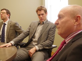 Soo Greyhounds forward Nick Cousins sits with his lawyer, Bruce Willson, following Thursday's announcement.