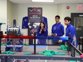 Three members of the Westwood Community High School robotics team — Anam Rizvi, Shubhum Patel and Nilay Patel — hone their skills in preparation for the world robotics championship set for the end of April in Anaheim. AMANDA RICHARDSON