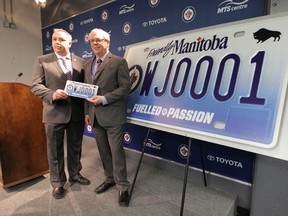 Premier Greg Selinger (left) with Dwayne Green of the Winnipeg Jets True North Foundation,  at a media conference at MTS Centre today where a cheque was presented to the Winnipeg Jets True North Foundation on behalf of the Manitoba Government and Manitoba Public Insurance.  The cheque, for more than $800,000, represents the proceeds from the sale of specialty Jets license plates.  A raffle will be held for the plate WJ0001.  Winnipeg, Thursday, April 4, 2013. (Chris Procaylo/Winnipeg Sun)