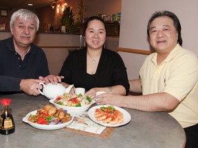From left, Greg Burliuk, Yan Yi Zhao and Don Lee. Lee and Zhao own the Silver Wok, a Chinese restaurant downtown Kingston. They want nothing more than to please their guests and make them leave full. Here there is Shanghai Style Fried Shrimp, Cantonese Chow Mein and Stirfry eggplant, pepper and potato. (LAURA BOUDREAU For the Whig-Standard)
