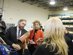 Federal NDP leader Tom Mulcair and Nickel Belt MPP France Gelinas look on as Jacqueline Fuller, right, of Dura 21, gives a tour of the business facilities at NORCAT in Sudbury, ON. on Thursday, April 4, 2013.  JOHN LAPPA/THE SUDBURY STAR/QMI AGENCY