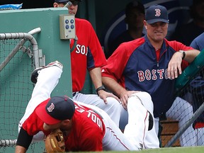 Red Sox Will Middlebrooks tries to make a play on a foul ball under the watchful eye of Red Sox manager and former Jays manager , John Farrell. (Craig Robertson/Toronto Sun)