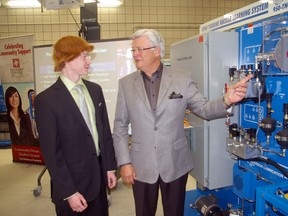 Matt Goossens, left, talks with Jim Wilgar, GDF Suez Canada Inc., after Goossens received the first bursary funded by the company for a student in Fanshawe College's renewable energy technician program.