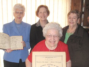 The Kent Regiment Chapter IODE is celebrating its 100th anniversary this month. Norma West, front, displays the original charter for the chapter, which was formed April 30, 1913. Also pictured, from back left, are Sheila DeJaegher,  holding, the chapter's first book of minutes, Garna Argenti, chapter president, and Gail Keller. (ELLWOOD SHREVE, Chatham Daily News)