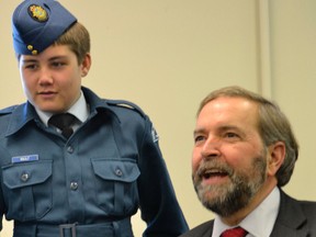 Cadet Nault of 10 Timmins Kiwanis Royal Canadian Air Cadet Squadron watches intently as federal NDP Leader Tom Mulcair soars through the virtual skies of the squadron's flight simulator. Mulcair and local MP Charlie Angus attended a special parade and reception held in their honour by the local Sea, Army, Air and Navy League Cadet units.