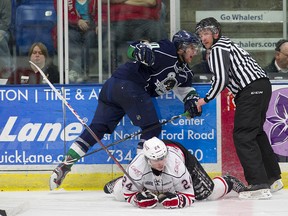 Tom Wilson of the Plymouth Whalers knocks over Chris Bigras of the Owen Sound Attack during the third period of the teams’ OHL Western Conference semifinal series opener in Plymouth, Mich., on Friday.