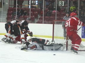 All eyes of turn to a loose puck which Nolan Ross of the Kenora Thistles was unable to bury on a 5-on-3 powerplay opportunity against the Saskatoon Contacts in 2013 Telus Cup Western Regional Champinships play Friday, April 5, 2013.
LLOYD MACK/Daily Miner and News