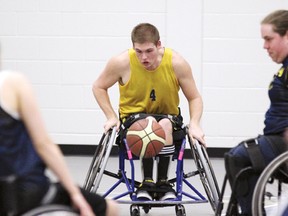 TINA PEPLINSKIE tina.peplinskie@sunmedia.ca
Sam Graham (centre), of Beachburg, a member of the Ottawa Jazz and Ottawa Royals, moves the ball up the court during a wheelchair basketball demonstration game held at Algonquin College in the Ottawa Valley recently. For more community photos, please visit our website photo gallery at www.thedailyobserver.ca.