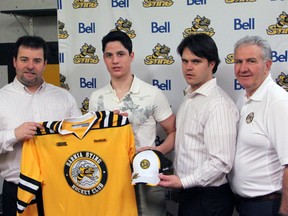 Sarnia product Justin Fazio, second from left, poses with Sarnia Sting general manager Jacques Beaulieu, left, director of player personnel Nick Sinclair, second from right, and area scout Jim Rauth after the Sting drafted him in the fourth round of the OHL Priority Selection Saturday, April 6, 2013 at the RBC Centre in Sarnia, Ont. PAUL OWEN/ THE OBSERVER/QMI AGENCY