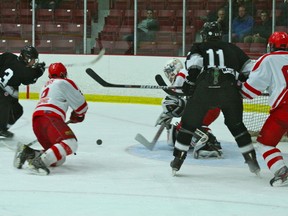Kenora's Cody Kaus dives across the ice to attempt to block a shot from Thunder Bay's Cashen Tighe while Thistles goalie Scott Parsons waits in net. The Midget Thistles lost game three of the Telus Cup Western Regionals 5-2 to the Thunder Bay Kings.

GRACE PROTOPAPAS/KENORA DAILY MINER AND NEWS