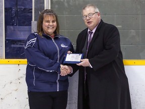 Kirkland Lake Gold Miners' trainer Carla Vine received her second team all star selection plaque from league Commissioner Robert Mazzuca before Friday's game against North Bay.