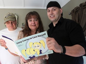 Debbie Matchett (centre) has published her first book, Lizzie Learns to Love Herself, with the help of illustrator Angel Brkic (right) and husband Barry (left), who helped launch the couple's company, Matlox Publishing. TARA JEFFREY/THE OBSERVER/QMI AGENCY