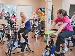 Marc Clare (left) annual campaign manager for the YMCA of Hamilton, Burlington, Brantford conducts a session during the Spin For Kids fund raising event at the YMCA on Wellington Street Saturday. (BRIAN THOMPSON The Expositor)