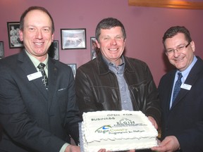 John Regan, left, general manager of the Elgin Business Resource Centre holds a cake celebrating the opening of a satellite office in the west region of Elgin County with Cameron McWilliam, ‌county warden and mayor of Dutton/Dunwich and Mark Masseo of EBRC who will staff the office, located in Dutton.
