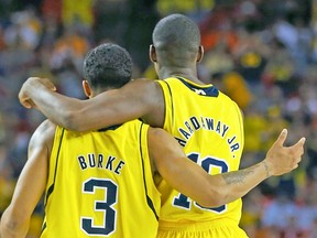 Michigan's Trey Burke and Tim Hardaway Jr. hug during their win over Syracuse on Saturday. (REUTERS)
