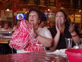 Rita Francella and her daughter Katrina cheer on Brad Jacobs in the Soo Curlers Association on Sunday.