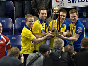 Brad Jacobs (left) watches as Sweden celebrates during the trophy presentation Sunday night.