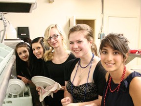 Girls from the leadership group wash dishes during the event.