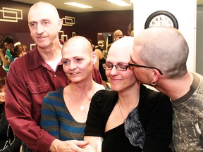 Twelve people had their heads shaved in support of Lisa Froment and her fight against cancer on Sunday afternoon at her hair salon on Spruce St. S. Foremost amongst those supporting her fight were family members. Her father Sylvan and mother Pauline stood proudly with shaven heads as Lisa is embraced and kissed on the cheek by her brother Joel.