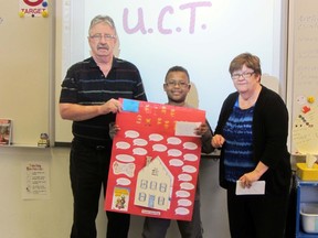 First place winner Nicholas Groom proudly displays his winning safety poster, Monday at Yellowquill School, alongside Wendell and Lynn Keeler of United Commercial Travelers (UCT). His poster will go on to a regional competition in Boissevain. (ROBIN DUDGEON/THE GRAPHIC/QMI AGENCY)