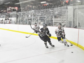 Whitecourt Wolverine defenceman Mathew Abt takes the puck deep into the Spruce Grove Saints zone and tries to evade Saints backchecker Connor Hoekstra in a playoff game at Scott Safety Centre on Monday, April 1. 
Barry Kerton | Whitecourt Star